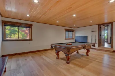 a pool table in a room with a ceiling at Bluebird Lodge by Tahoe Getaways - 4 BR with Hot Tub, Pool Table & Lake Views in Carnelian Bay