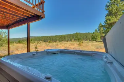 a jacuzzi tub in the middle of a yard at Bitter Brush by Tahoe Getaways -4 BR Pet Friendly, Northstar Home with Hot Tub, Pool Table, & Ski Shuttle in Truckee