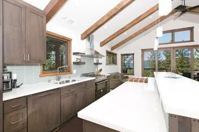 a kitchen with wooden cabinets and white countertops at Beaver Lake View by Tahoe Getaways - Pet Friendly 3 BR with Hot Tub, Wood Fireplace & Close to Skiing in Kings Beach