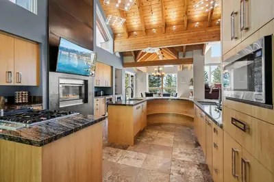 a large kitchen with wooden cabinets and a stove top oven at Mountain Zen Tahoe Luxury Property Incline Village Lakeview in Incline Village