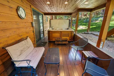 a porch with a bench and chairs and a stove at Mountain Zen Tahoe Luxury Property Incline Village Lakeview in Incline Village