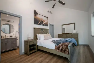 a bedroom with a bed and a sink and a mirror at Luxury Villa in Sierra Mountains in Alta