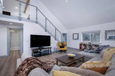 a living room with a couch and a flat screen tv at Luxury Villa in Sierra Mountains in Alta