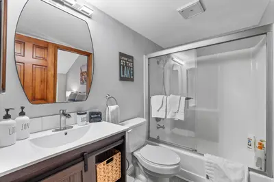 a bathroom with a sink and a toilet and a mirror at Alpine Escape: Tahoe Oasis Steps from Lake in Carnelian Bay