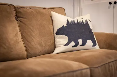 a black and white bear pillow on a couch at Alpine Escape: Tahoe Oasis Steps from Lake in Carnelian Bay