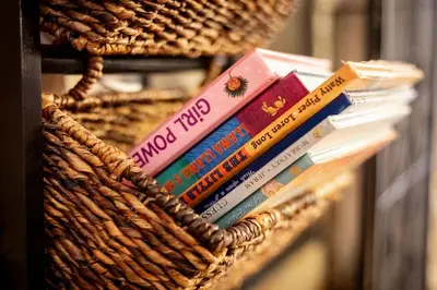 a basket full of books on a shelf at Alpine Alcove: Tahoe Tranquility Near Kings Beach in Tahoe Vista