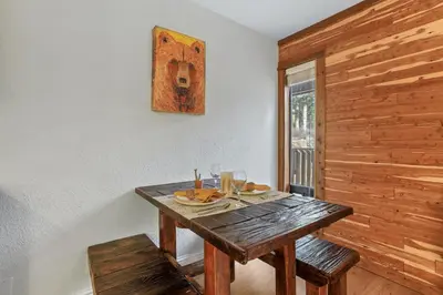 a wooden table in a room with a window at Alpine Alcove: Tahoe Tranquility Near Kings Beach in Tahoe Vista