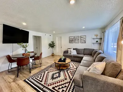 a living room with a couch and a table at Adventure Lodge in South Lake Tahoe