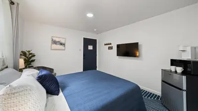 a hotel room with a bed and a tv at Adventure Lodge in South Lake Tahoe