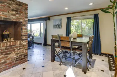 a dining room with a brick wall and a table and chairs at Spacious Reno Vacation Rental about 3 Mi to MidTown! in Reno