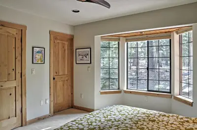 a bedroom with a bed and two windows at Truckee Northstar Family Home by Jaeger Retreat in Truckee