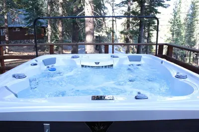a jacuzzi tub in the middle of a yard at Camp Telemark by Tahoe Getaways - Pet-Friendly 3 BR in Tahoe Donner with Hot Tub & Wood Fireplace in Truckee