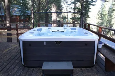 a hot tub sitting on top of a deck at Camp Telemark by Tahoe Getaways - Pet-Friendly 3 BR in Tahoe Donner with Hot Tub & Wood Fireplace in Truckee