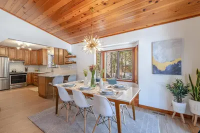 a kitchen and dining room with a table and chairs at Camp Telemark by Tahoe Getaways - Pet-Friendly 3 BR in Tahoe Donner with Hot Tub & Wood Fireplace in Truckee