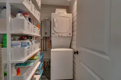 a kitchen with an open refrigerator and shelves at Blackwood Bungalow on the West Shore by Tahoe Getaways - 3 BR Pet Friendly & Walking Distance to the Lake in Homewood