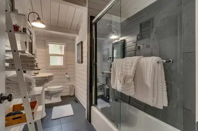 a bathroom with a shower and a sink and a toilet at Blackwood Bungalow on the West Shore by Tahoe Getaways - 3 BR Pet Friendly & Walking Distance to the Lake in Homewood
