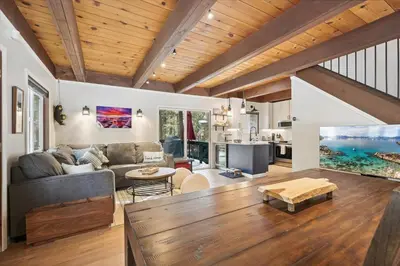 a living room with a couch and a table at Cobalt Cabin by Tahoe Getaways - Beautifully Remodeled Pet Friendly 3 BR with Hot Tub & EV in Carnelian Bay