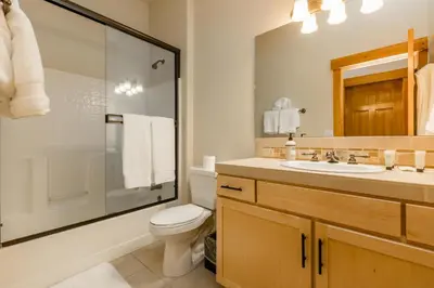a bathroom with a toilet and a sink and a shower at Cedar Crest at Winter Creek by Tahoe Getaways - 3BR, Walk to Ice Skating, Near Downtown and Northstar with Private Hot Tub! in Truckee
