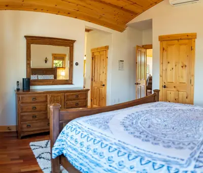 a bedroom with a bed and a dresser and a mirror at Coyote Run Retreat by Tahoe Getaways - 3BR Pet Friendly with HOA Amenities, Minutes to Downtown Truckee & Northstar Resort! in Truckee