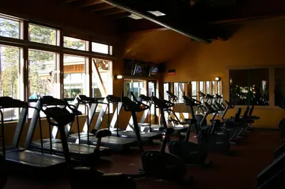 a gym with rows of treadmills in a room at Cottonwood by Tahoe Getaways - 3BR Tahoe Donner with 2 Bonus Rooms, Hot Tub, Fireplace, Ping Pong & HOA Amenities in Truckee