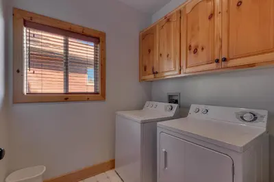 a laundry room with a washer and dryer at Crystal Lakeview Lodge by Tahoe Getaways - Private Hot Tub, Foosball Table & Tahoe Park HOA in Tahoe City