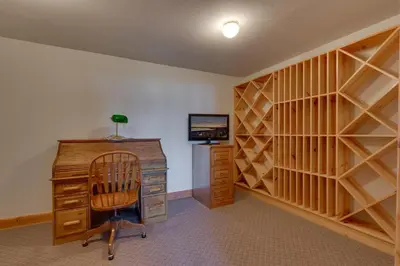 a room with a desk and a computer and a television at Crystal Lakeview Lodge by Tahoe Getaways - Private Hot Tub, Foosball Table & Tahoe Park HOA in Tahoe City