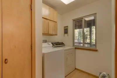 a small kitchen with a stove and a window at Deer Hollow by Tahoe Getaways at Northstar - 4BR w Hot Tub, Ski Shuttle, & HOA Amenities in Truckee