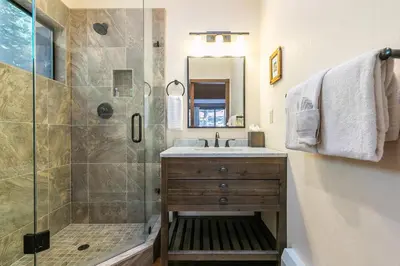 a bathroom with a shower and a sink at Basque Lodge at Northstar by Tahoe Getaways - Pet-Friendly 5BR w Free Shuttle & HOA Amenities in Truckee