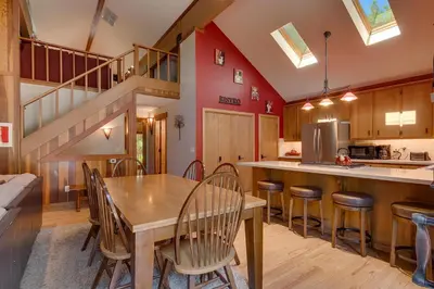 a kitchen and dining room with a wooden table and chairs at Club 151 at Dollar Point by Tahoe Getaways - Pet-Friendly 4BR w Hot Tub & Fenced Yard in Tahoe City