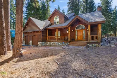 a log home with a gambrel roof at Fox Crossing at Tahoe Donner by Tahoe Getaways - 3BR Vacation Rental w Forested Views & HOA Amenities! in Truckee