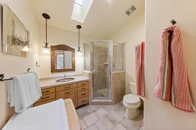 a bathroom with a shower and a toilet and a sink at Fox Crossing at Tahoe Donner by Tahoe Getaways - 3BR Vacation Rental w Forested Views & HOA Amenities! in Truckee