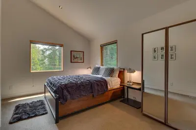a bedroom with a bed and a window at Mod Haus by Tahoe Getaways - Mountain Modern West Shore Home w Private Beach and Pier, Near Skiing in Homewood
