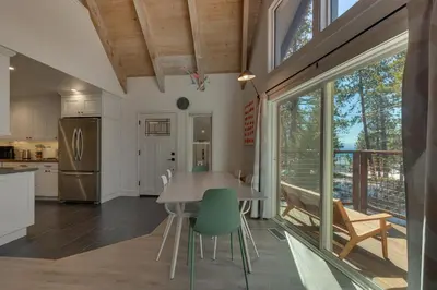 a kitchen and dining room with a table and chairs at Moon Dune Chalet by Tahoe Getaways - Remodeled 3 BR Cabin plus Loft w Fenced Yard & Walk to Beach or Dining in Tahoe Vista