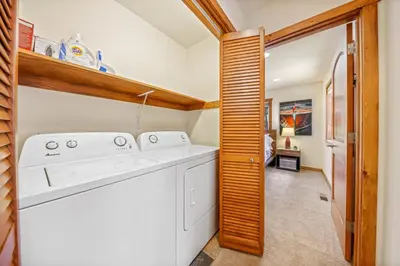 a laundry room with a washer and dryer at Sunlit Pines by Tahoe Getaways - 2BR in Tahoe Park w Hot Tub, Fenced Yard & Pet Friendly! in Tahoe City