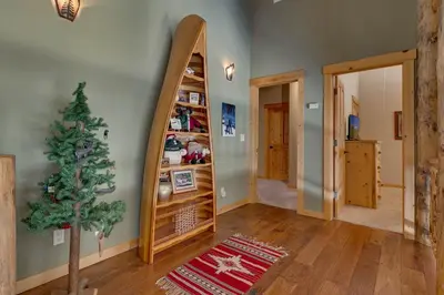 a room with a christmas tree and a mirror at Tippy Canoe by Tahoe Getaways - 4BR West Shore w Private Hot Tub,, Sauna, EV & Walking Distance to Trailhead in Tahoma