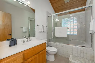 a bathroom with a tub and a sink and a toilet at Tree Haus by Tahoe Getaways - Unique Pet-Friendly Tahoe Donner Home w EV & HOA Pool & Beach in Truckee