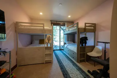 a bedroom with two bunk beds and a desk at Truckee Luxe by Tahoe Getaways - 3 BR Luxury Gray's Crossing Townhome w Hot Tub on Golf Course - Close to Downtown & Northstar in Truckee