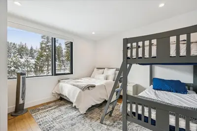 a bedroom with two bunk beds and a window at Diamond Run at Palisades - Luxury Townhome, Ski Shuttle Pet Friendly and Hot Tub! in Olympic Valley