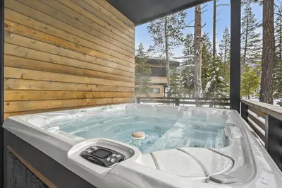 a jacuzzi tub on the deck of a house at Diamond Run at Palisades - Luxury Townhome, Ski Shuttle Pet Friendly and Hot Tub! in Olympic Valley