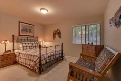 a bedroom with a bed and a chair and a window at Fireside Lodge at Northstar By Tahoe Getaways - 4BR w Hot Tub, HOA & Ski Shuttle in Truckee