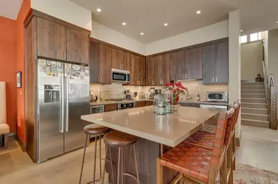 a kitchen with a counter and a refrigerator at Gondola Getaway- Ski-in Ski-out - Luxury 4 BR, Private Hot Tub, HOA Amenities in Truckee