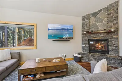 a living room with a couch and a fireplace at Graystone Retreat - Modern Retreat w Hot Tub & HOA Amenities in Truckee