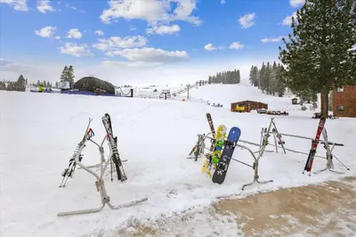 a bunch of skis are lined up in the snow at Graystone Retreat - Modern Retreat w Hot Tub & HOA Amenities in Truckee