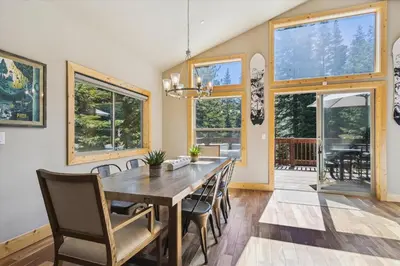 a dining room with a wooden table and chairs at Graystone Retreat - Modern Retreat w Hot Tub & HOA Amenities in Truckee