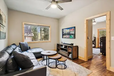 a living room with a couch and a table at Graystone Retreat - Modern Retreat w Hot Tub & HOA Amenities in Truckee