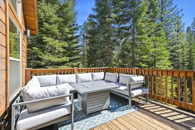 a patio with a couch and chairs on a deck at Graystone Retreat - Modern Retreat w Hot Tub & HOA Amenities in Truckee