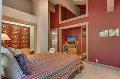 a bedroom with a large bed and a tv at High Sierra at Dollar Point - Private Hot Tub, Close to Ski Resorts, Pet Friendly! in Tahoe City