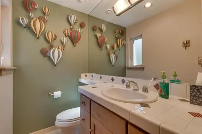 a bathroom with a sink and a toilet and a mirror at High Sierra at Dollar Point - Private Hot Tub, Close to Ski Resorts, Pet Friendly! in Tahoe City