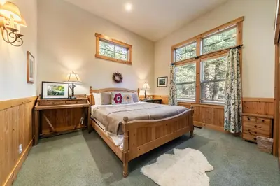 a bedroom with a bed and a window at Indian Hills at Northstar by Tahoe Getaways - Spacious 4 BR, Private Hot Tub, Wood Fireplace, and HOA Amenities in Truckee