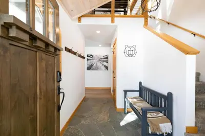 a hallway with a wooden door and a bench at Kokanee at Tahoe Donner - Charming 3 BR - Pool Table - Fireplace - Amenity Access! in Truckee